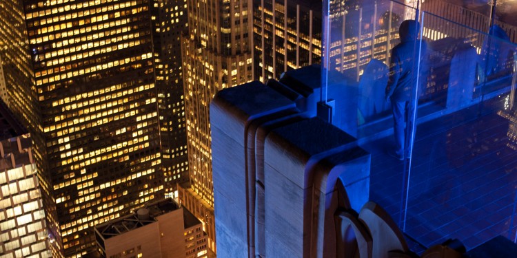 A visitor looks out over Manhattan from the observation deck of 30 Rockefeller Center