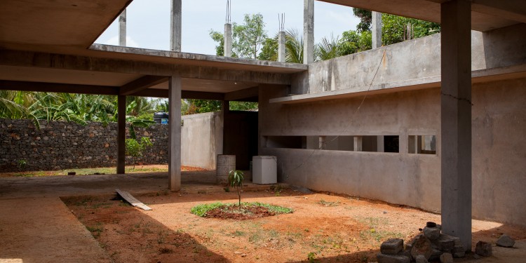 A palm tree sapling planted in the middle of an atrium in a construction site just outside Anuradhapura.